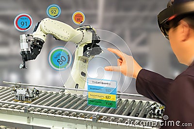 Iot industry 4.0 concept,industrial engineerblurred using smart glasses with augmented mixed with virtual reality technology to Stock Photo