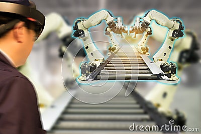 Iot industry 4.0 concept,industrial engineerblurred using smart glasses with augmented mixed with virtual reality technology to Stock Photo