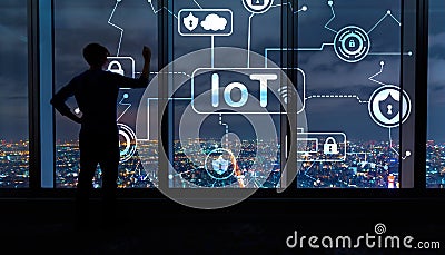 IoT security theme with man by large windows at night Stock Photo