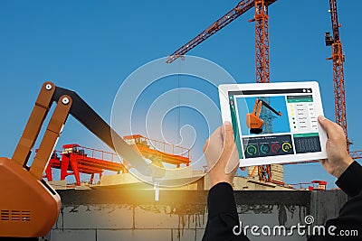 Iot smart factory , industry 4.0 technology concept, Engineer use tablet to monitor, detect and analysis the robot arm for constru Stock Photo