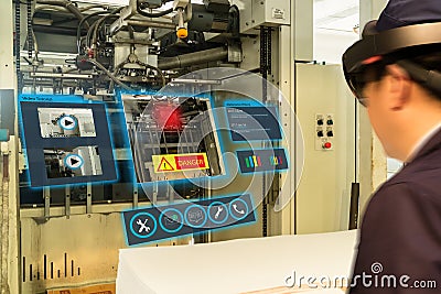 Iot smart industry 4.0 concept. Industrial engineerblurred using smart glasses with augmented mixed virtual reality technology t Stock Photo