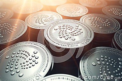 IOTA coins in blurry closeup with sunburst from above. IOTA growth concept. Stock Photo