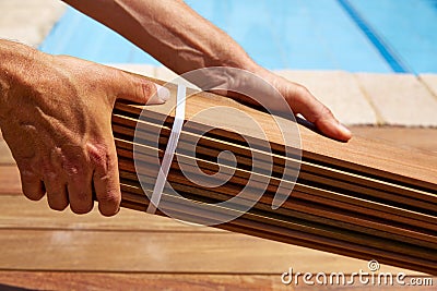 Ipe deck installation carpenter hands holding wood Stock Photo