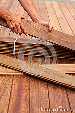Ipe deck installation carpenter hands holding wood Stock Photo