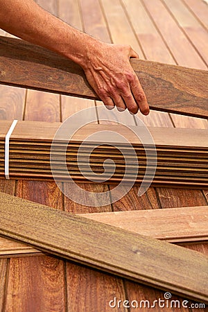 Ipe deck installation carpenter hands holding wood Stock Photo