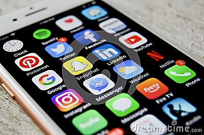 iPhone with assortment of apps displayed Editorial Stock Photo