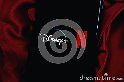 IPhone with the DISNEY PLUS and NETFLIX logo Editorial Stock Photo