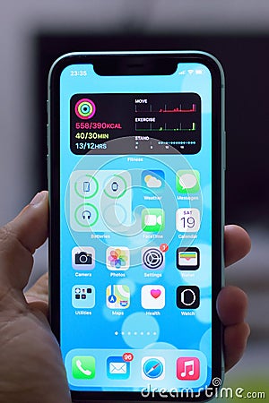 IPhone 11 with new home screen widgets of iOS14 Editorial Stock Photo
