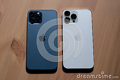 IPhone 13 Pro Max in Silver and iPhone 12 Pro Max in Pacific Blue. Editorial Stock Photo