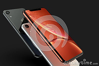 3 iPhone XR coral, silver and Space Grey smart phones on black Editorial Stock Photo