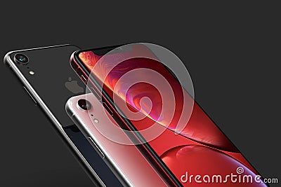 3 iPhone XR Red, silver and Space Grey smart phones on black Editorial Stock Photo