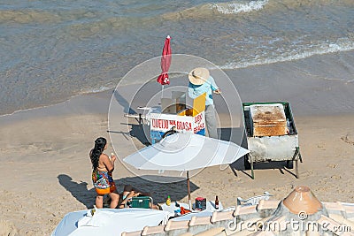Man selling grilled cheese and drinks on a food cart at Porto de Galinhas beach Editorial Stock Photo