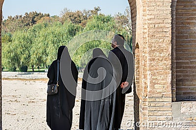 Iran Visitors standing at the Arch of Allahverdi Khan Bridge, also known as Si-o-seh pol or bridge of thirty-three spans, Esfahan Editorial Stock Photo