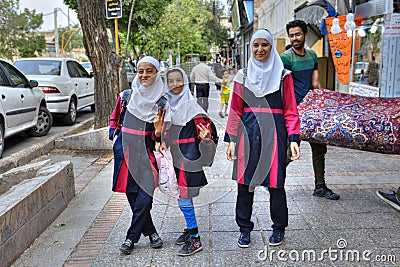 Iranian girls in school uniform on a city street. Editorial Stock Photo