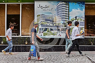 Iranian men walk down the street with shops, Tehran, Iran. Editorial Stock Photo