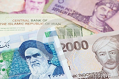 Iranian Rial and Indonesian money Rupiah banknotes. Stock Photo