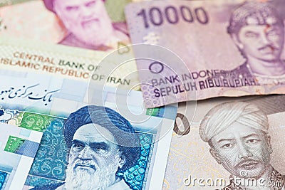 Iranian Rial and Indonesian money Rupiah banknotes. Stock Photo