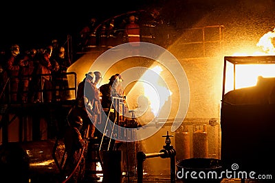 Irefighters practicing firefighting using hose and water Editorial Stock Photo