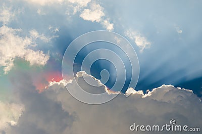 Iridescence, Nice rainbow at clouds with ray Stock Photo