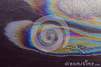 Iridescent spot of gasoline on the pavement Stock Photo