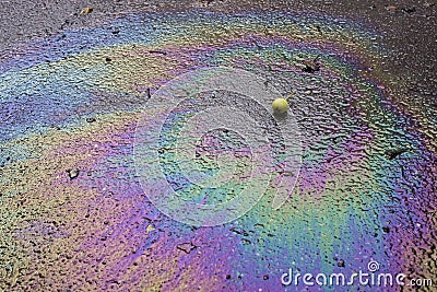 Iridescent spot of gasoline. Petrol on the asphalt a big polluted puddle water. A rainbow slick of gasoline Stock Photo