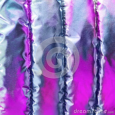 The iridescent texture of the bologna fabric of the quilted youth jacket. Pink neon in trendy style background. Stock Photo