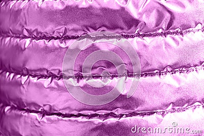 The iridescent texture of the bologna fabric of the quilted youth jacket. Pink neon in trendy style background. Stock Photo