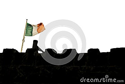 Irish flag over a dark castle wall silhouette. Stock Photo