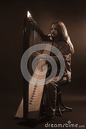 Irish harp player. Musician harpist Stock Photo