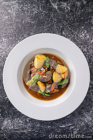 Irish Stew or Guinness Stew made in a crockpot or slow cooker top view, flat lay Stock Photo