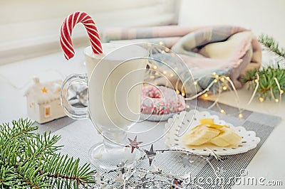 Irish traditional winter cream cocktail eggnog in a glass mug with milk, rum and cinnamon, banana covered with whipped cream, Stock Photo