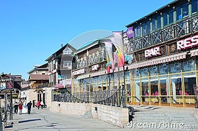 Irkutsk, Russia, March, 17, 2017. People walking in old styled 130-th quarter in Irkutsk Editorial Stock Photo