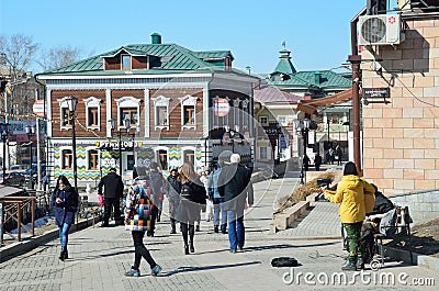 Irkutsk, Russia, March, 17, 2017. People walking in old styled 130-th quarter in Irkutsk Editorial Stock Photo