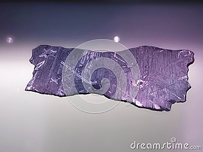 Iron alien meteorite with Widmanstatten pattern on light Stock Photo