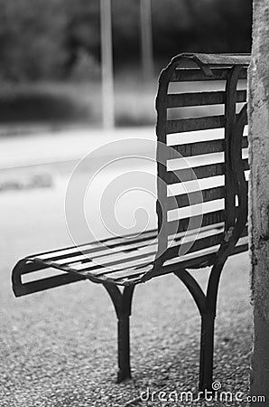 An iron bench , empty and in black and white Stock Photo