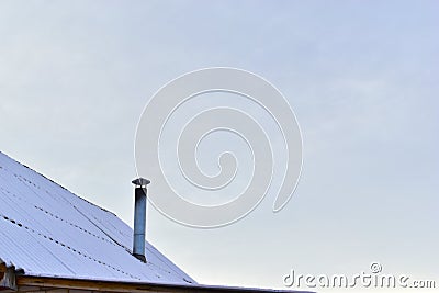 The iron chimney pipe that is covered with snow in winter Stock Photo