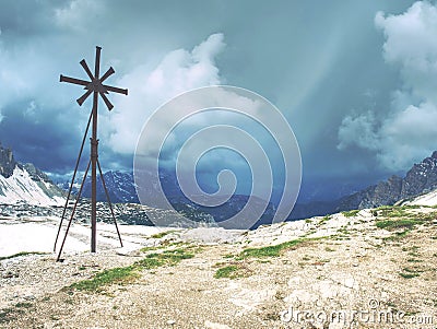 Iron cross at path around mountain Drei Zinnen in South Tyrol Stock Photo