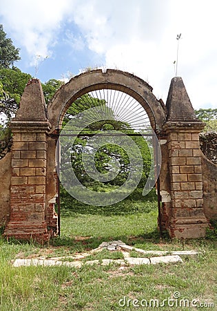Iron door and stone walls of colonial coffe plantation Stock Photo
