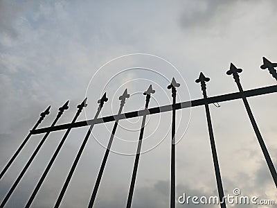 iron fence with pointed ends as a boundary between figures for safety Stock Photo