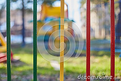 Iron fence strips green, yellow and red Stock Photo