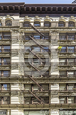 Iron fire ladder at the facade of an old historic house in New York Editorial Stock Photo