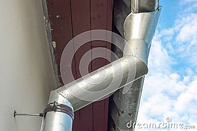 Iron gutter on the roof. Country house water drainage system Stock Photo