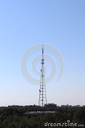 Iron high tower for signal transmission against the blue sky. Stock Photo