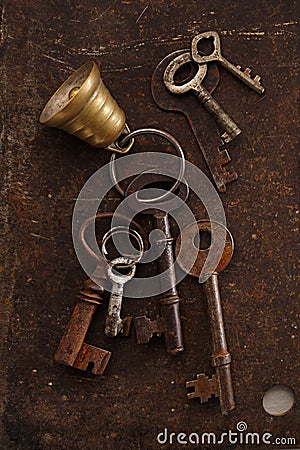 Iron keys with bell on metal backdrop Stock Photo