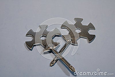 Iron keys with a screwdriver on a gray background. Stock Photo