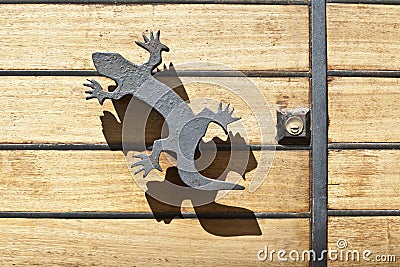Iron lizard handle and shadow Stock Photo