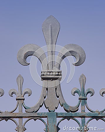 Iron made fleur de lis symbol on a fence Stock Photo