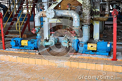 Iron metal centrifugal pumps equipment and pipes with flanges and valves for pumping liquid fuel products at industrial refinery Stock Photo