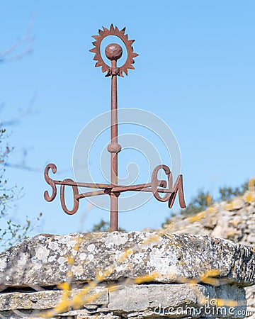 Iron piece that marks the cardinal points with a sphere and iron ring at the top. compass Stock Photo