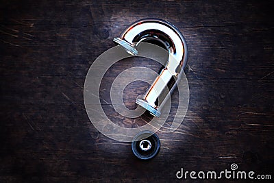 Iron pipe question symbol wooden sharp table Stock Photo